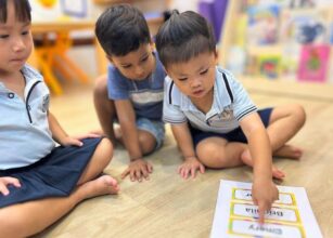 Starshine Montessori Preschool children participating in a name recognition and language activity in a Montessori-style classroom setting.