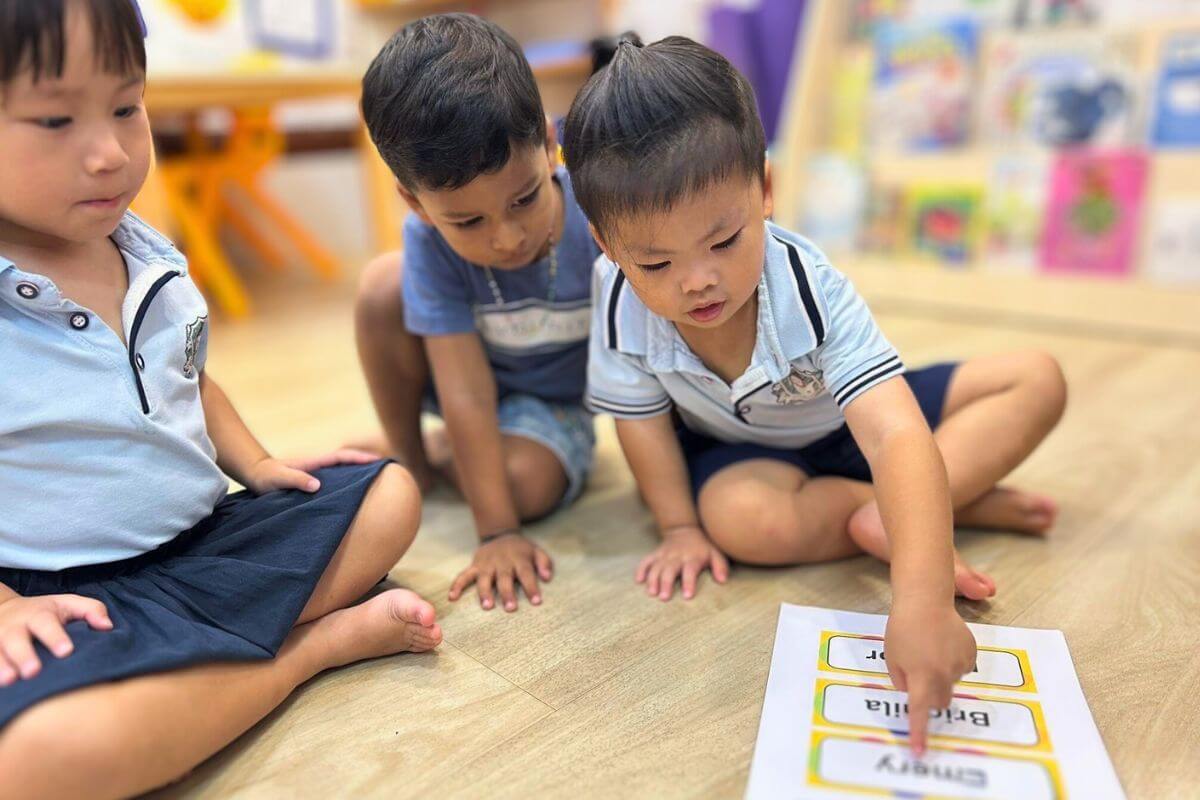 Starshine Montessori Preschool children participating in a name recognition and language activity in a Montessori-style classroom setting.