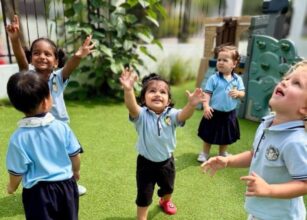 Preschool children at Starshine Montessori joyfully playing outdoors on a sunny day, engaging in bubble play and outdoor learning.