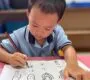 Child writing chinese characters Starshine Montessori 90x80